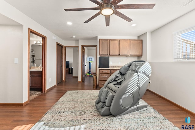 interior space featuring ceiling fan, built in desk, and dark hardwood / wood-style floors