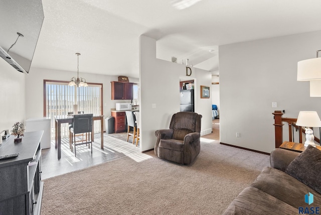 living room featuring light carpet, vaulted ceiling, a chandelier, and a textured ceiling