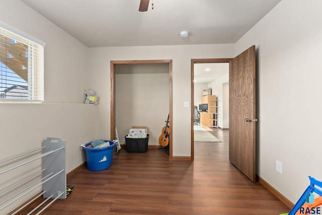 interior space with ceiling fan and dark hardwood / wood-style floors