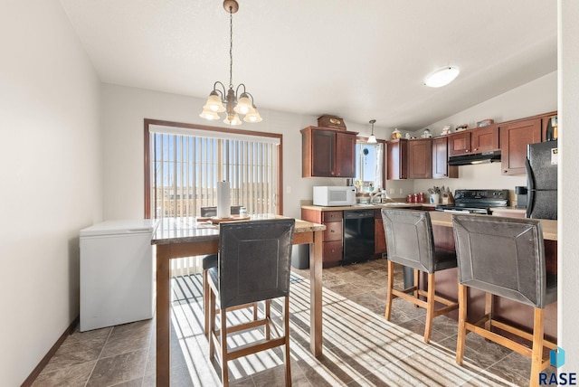 kitchen featuring an inviting chandelier, a kitchen breakfast bar, vaulted ceiling, pendant lighting, and black appliances