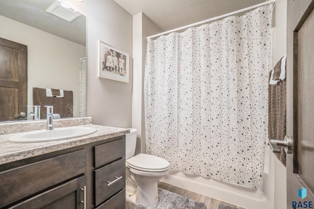 bathroom featuring toilet, a shower with shower curtain, hardwood / wood-style floors, and vanity