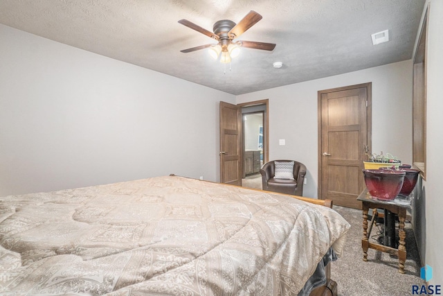 bedroom featuring a textured ceiling, ceiling fan, and carpet floors