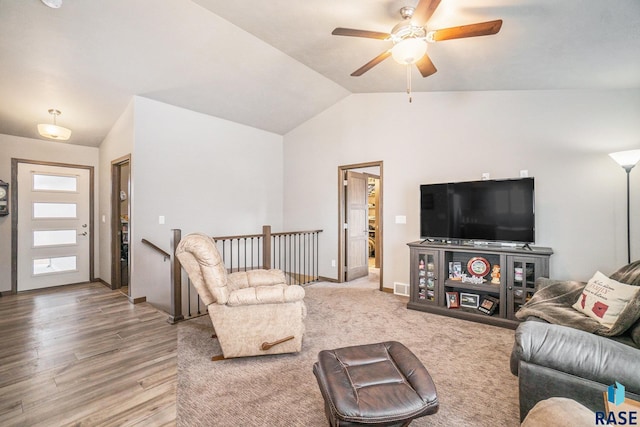 living room with vaulted ceiling, ceiling fan, and wood-type flooring