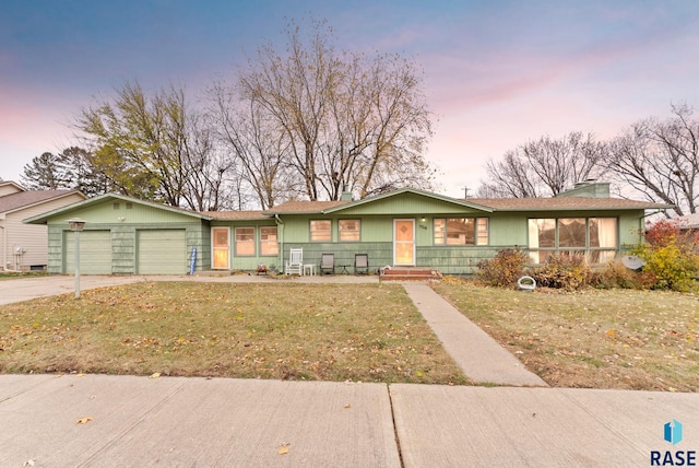 single story home with a yard and a garage