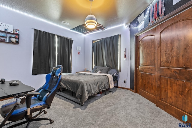 carpeted bedroom with a textured ceiling and ceiling fan