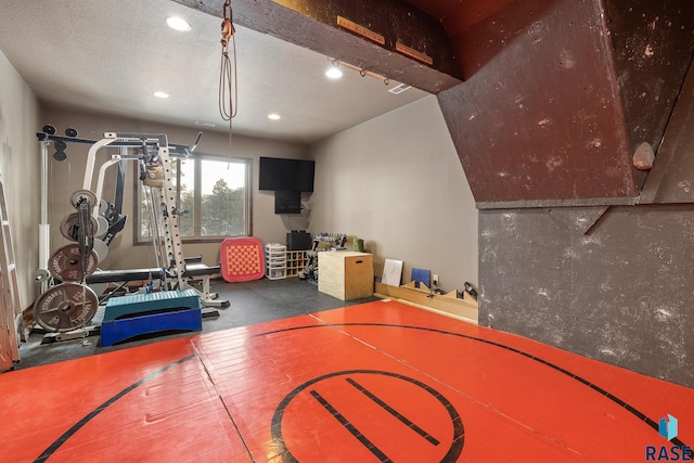 interior space featuring rail lighting and a textured ceiling