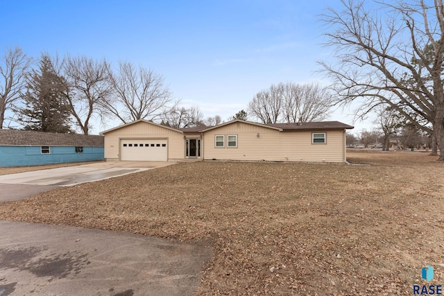 single story home with a garage and a front yard