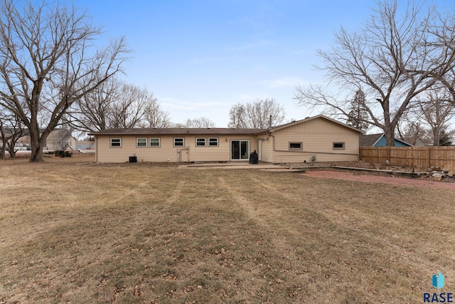 rear view of property with a yard and a patio