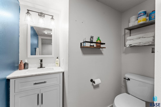 bathroom with toilet and vanity