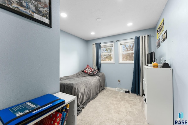 bedroom featuring light carpet