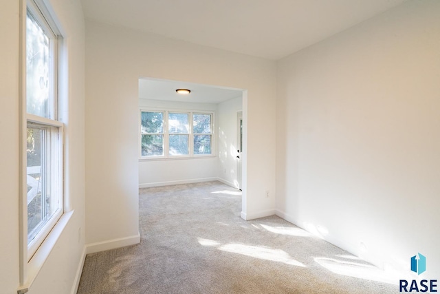 spare room featuring light colored carpet