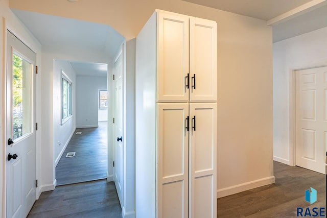 hallway with dark wood-type flooring