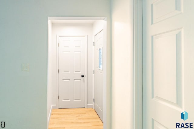 hall with light hardwood / wood-style floors