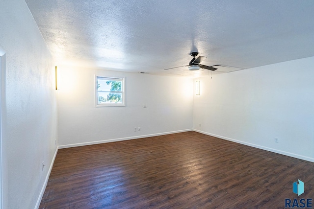 unfurnished room featuring a textured ceiling, ceiling fan, and dark hardwood / wood-style flooring