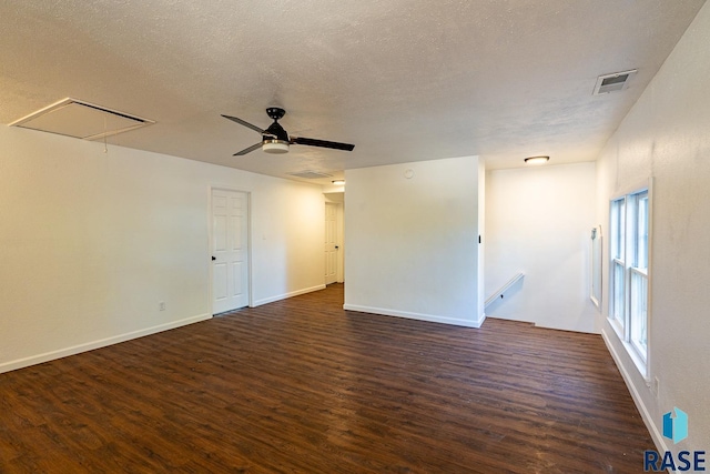 unfurnished room featuring ceiling fan, a textured ceiling, and dark hardwood / wood-style floors