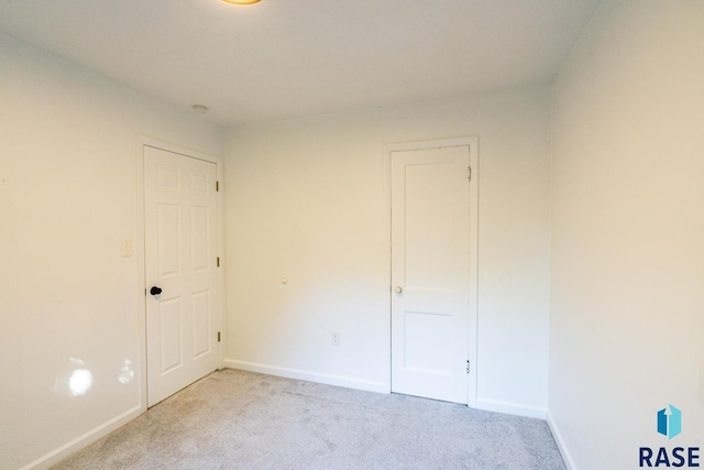 empty room featuring light colored carpet