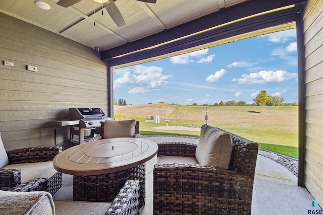 view of patio with ceiling fan, a rural view, and area for grilling