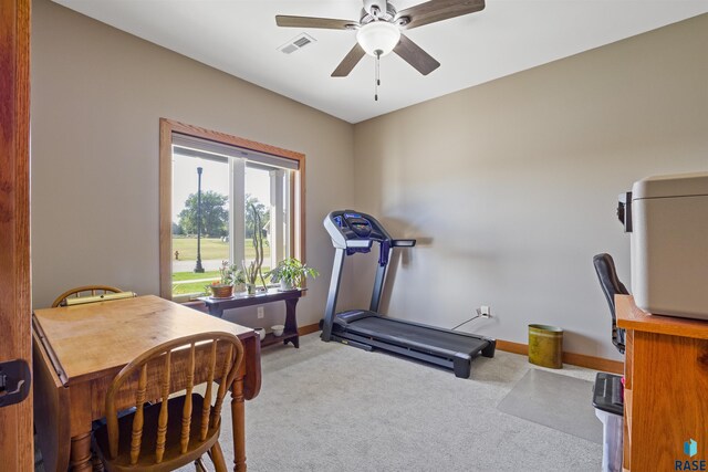 exercise room featuring light carpet and ceiling fan