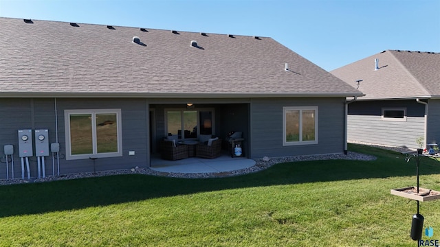 rear view of house featuring a lawn and a patio