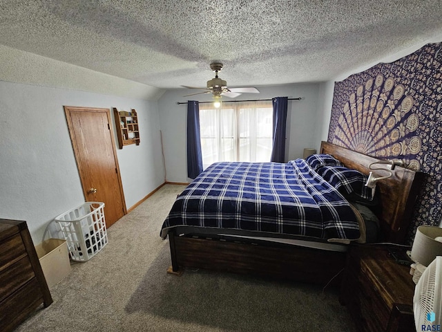 carpeted bedroom featuring ceiling fan, a textured ceiling, and lofted ceiling