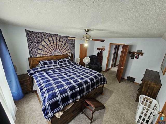 carpeted bedroom featuring a textured ceiling and ceiling fan