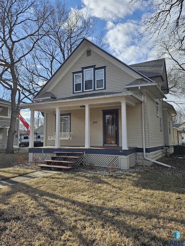 view of front facade with a front lawn and a porch