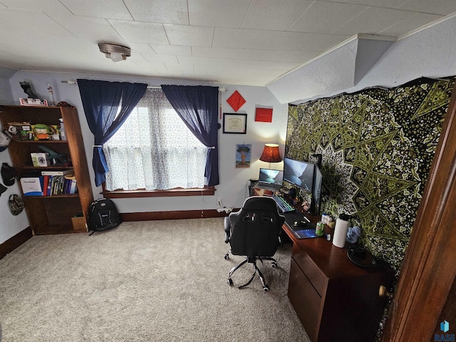 carpeted home office featuring lofted ceiling