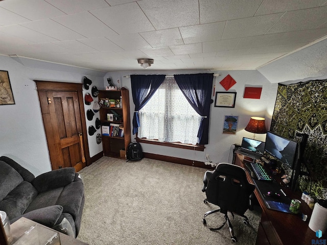 carpeted office with lofted ceiling