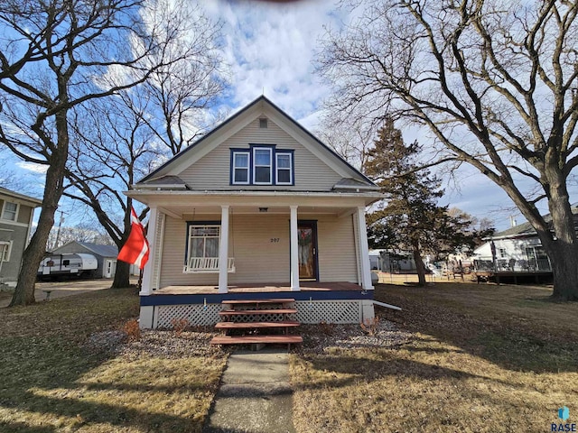 bungalow-style house featuring a porch and a front yard