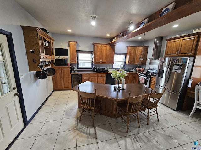 tiled dining area with a textured ceiling, beverage cooler, and sink