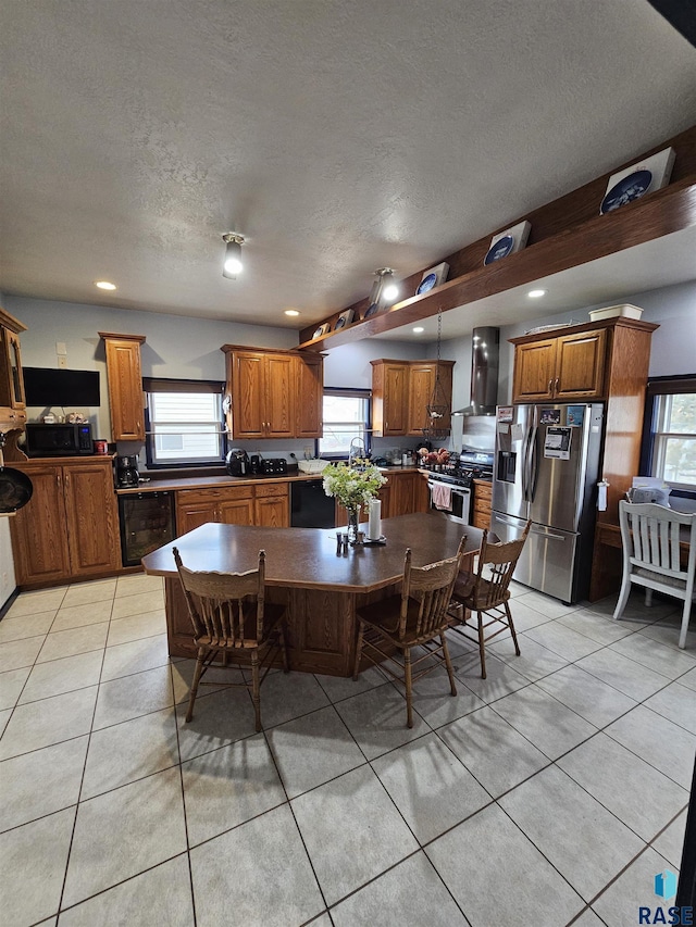 dining room with a textured ceiling, light tile patterned floors, and sink