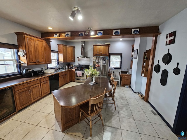 kitchen featuring appliances with stainless steel finishes, a center island, wall chimney exhaust hood, sink, and light tile patterned flooring