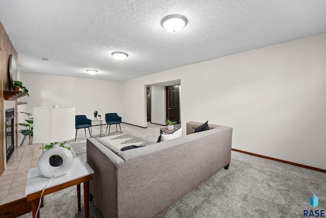 living area with baseboards, visible vents, light colored carpet, and a glass covered fireplace