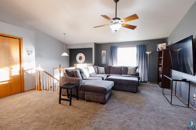 carpeted living room featuring ceiling fan and lofted ceiling