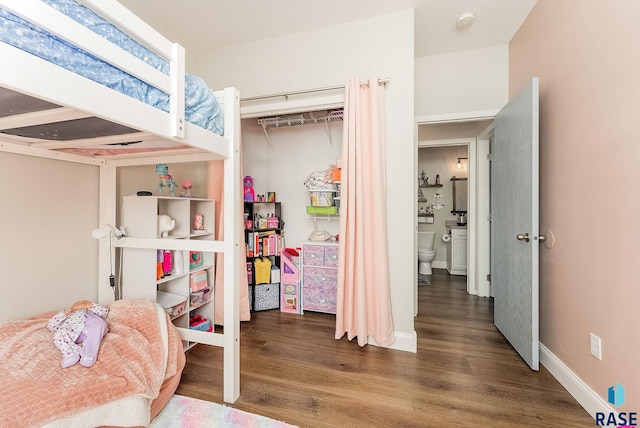 bedroom with dark hardwood / wood-style floors