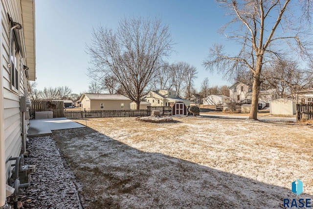 view of yard featuring a storage shed and a patio