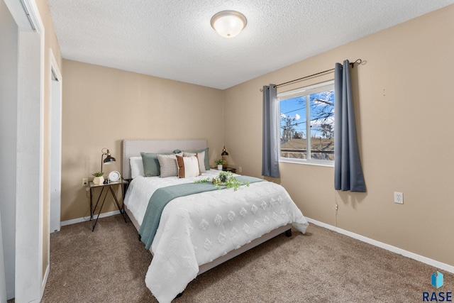 carpeted bedroom featuring a textured ceiling