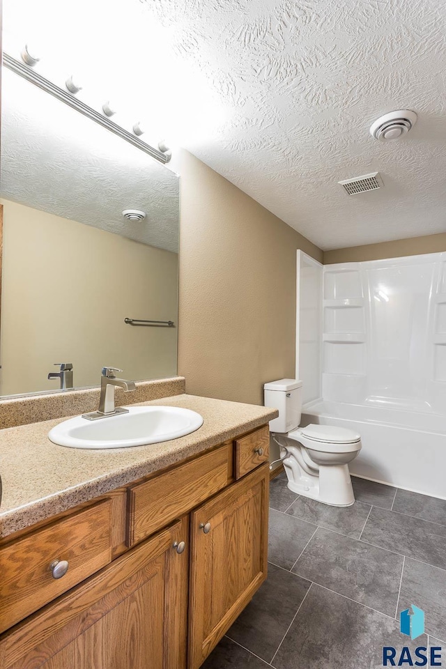 full bathroom with toilet, vanity, shower / bath combination, and a textured ceiling