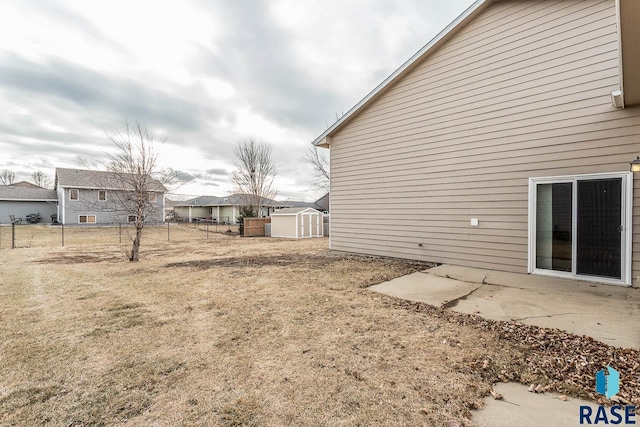 view of yard with a storage unit and a patio