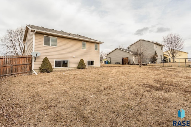 rear view of house with a yard