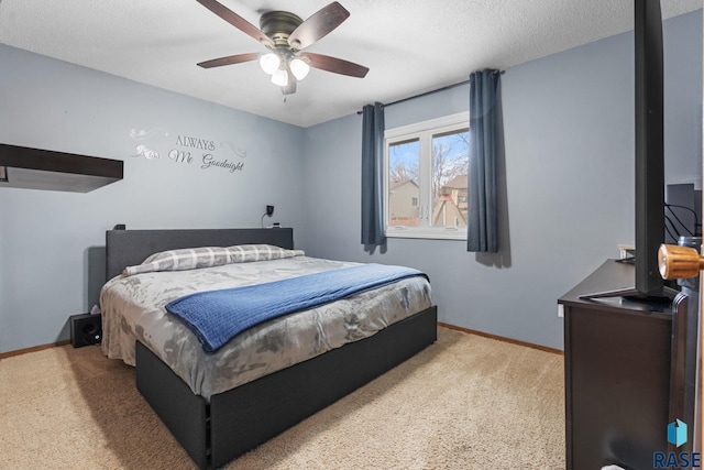 bedroom featuring light carpet, a textured ceiling, and ceiling fan