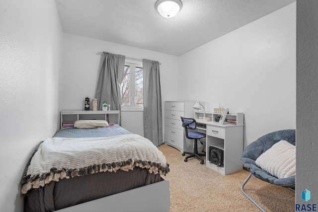 carpeted bedroom featuring a textured ceiling