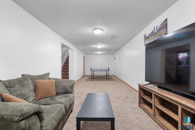 carpeted living room featuring a textured ceiling