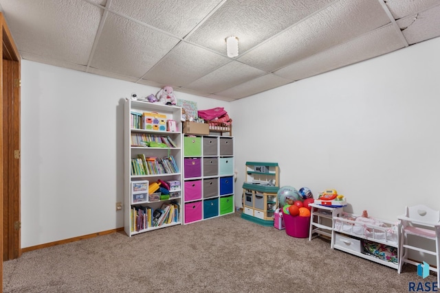 playroom featuring carpet flooring and a paneled ceiling