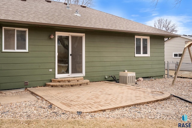 rear view of house featuring a patio and central air condition unit