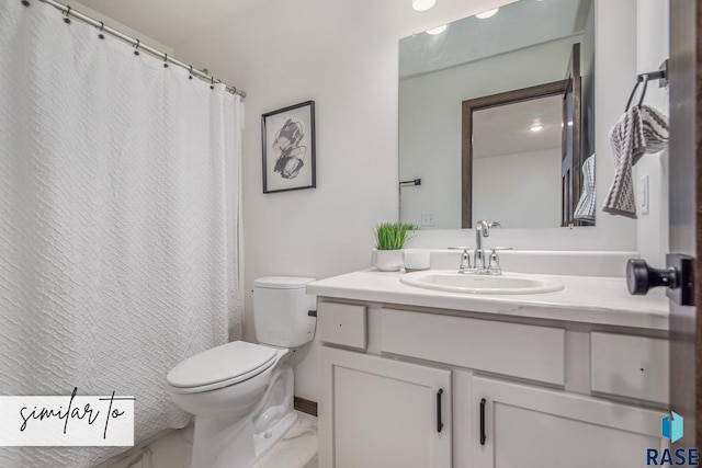 bathroom with toilet and vanity