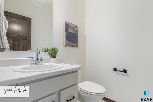 bathroom with toilet and vanity