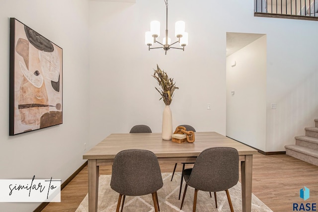 dining area featuring light hardwood / wood-style flooring and an inviting chandelier