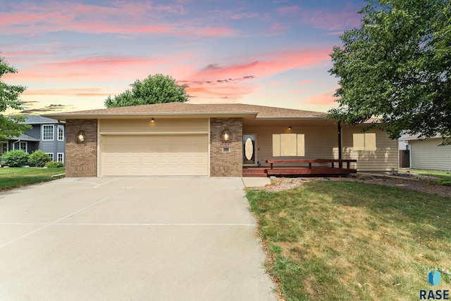 view of front of property featuring a yard and a garage