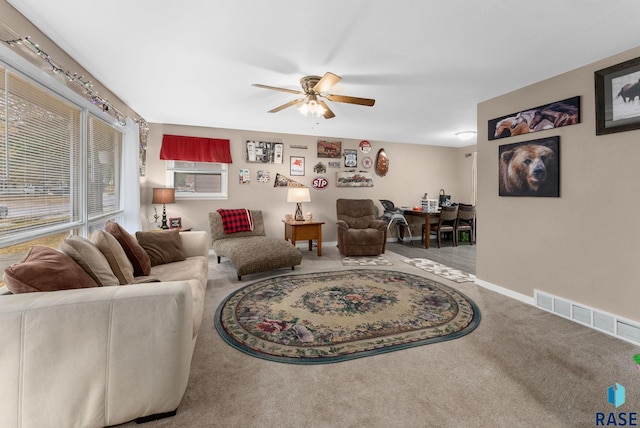 living room with ceiling fan and carpet floors